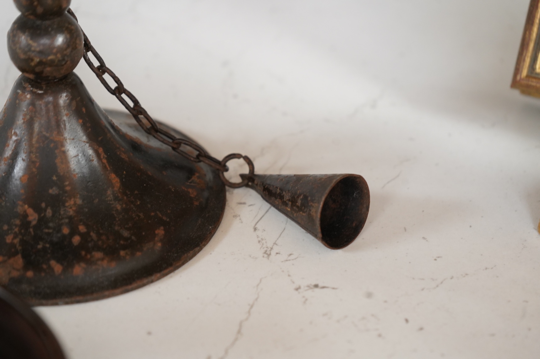 A pair of 19th century toleware wine coasters and an Arts & Crafts iron candlestick with attached snuffer, 21cm high